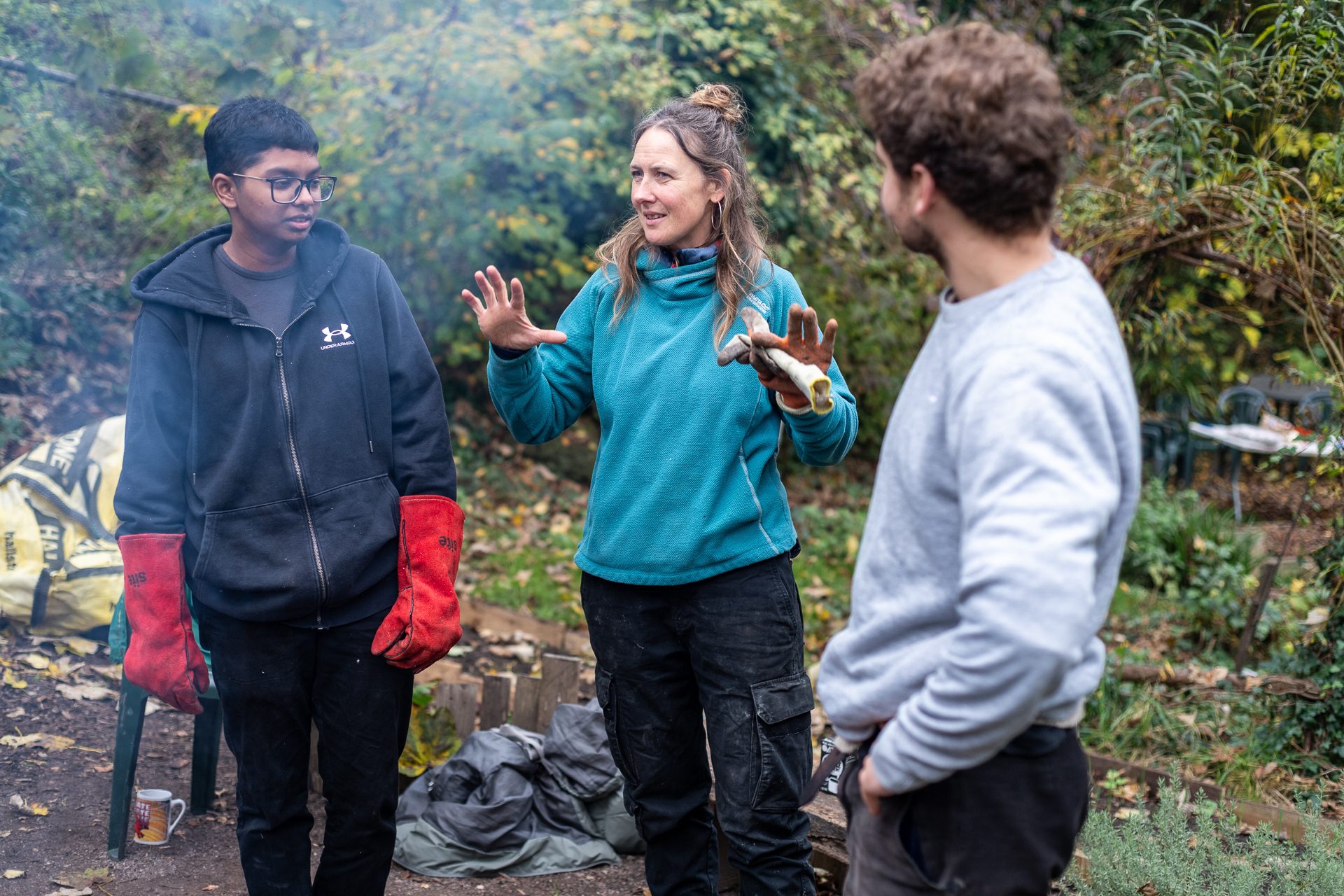 Three people talking in a community garden