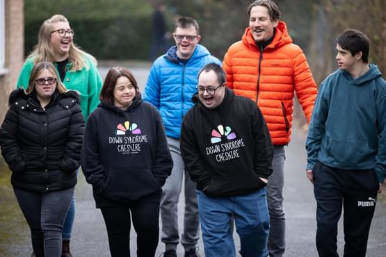 Group of people walking and laughing