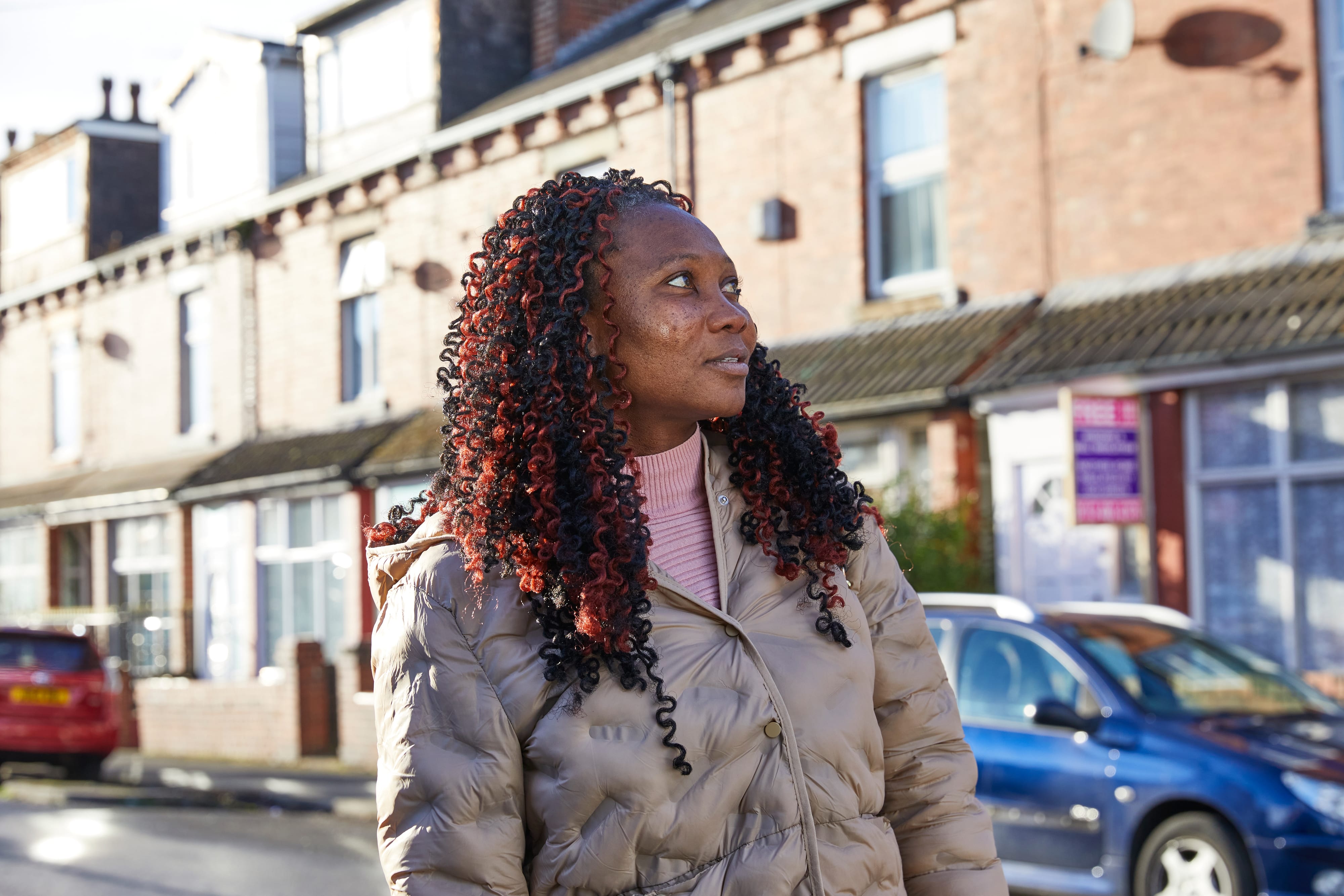 Woman standing in a terraced street in Harehills, Leeds