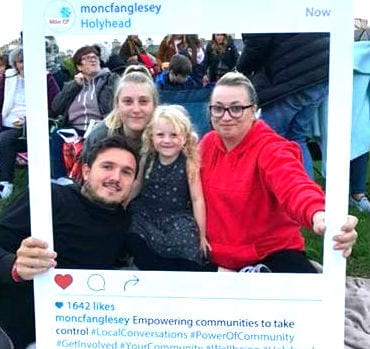 Local people enjoying an outdoor event organised by Mon CF, Anglesey