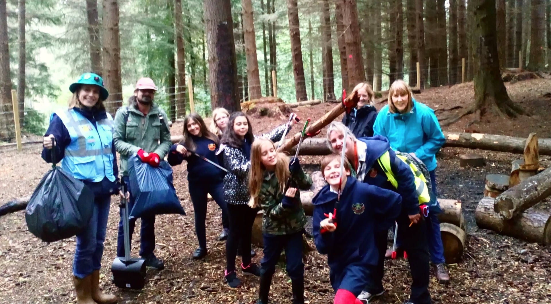Members of the Local People project litter-picking in a woodland