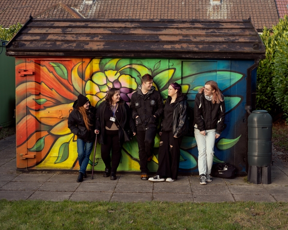 picture for projectStory: A group of young people standing outside in front colourful building community garden. picture for projectStory: A group of young people standing outside in front colourful building community garden.
