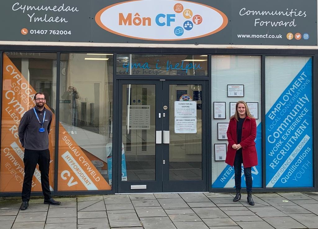 Two people stood outside the Mon CF community building