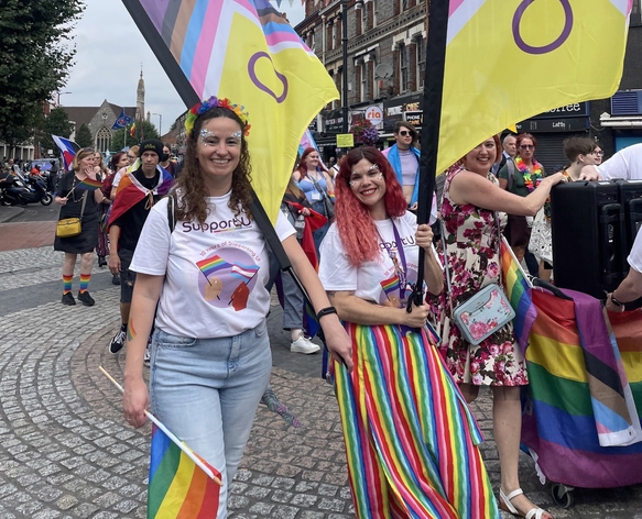 picture for projectStory: Two people holding flags at a Pride march picture for projectStory: Two people holding flags at a Pride march