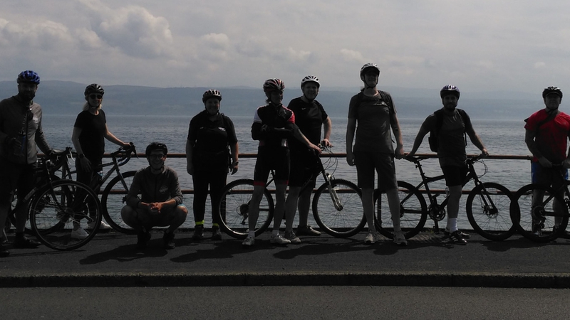 picture for projectStory: Cyclists standing by a beach front with their bikes. picture for projectStory: Cyclists standing by a beach front with their bikes.