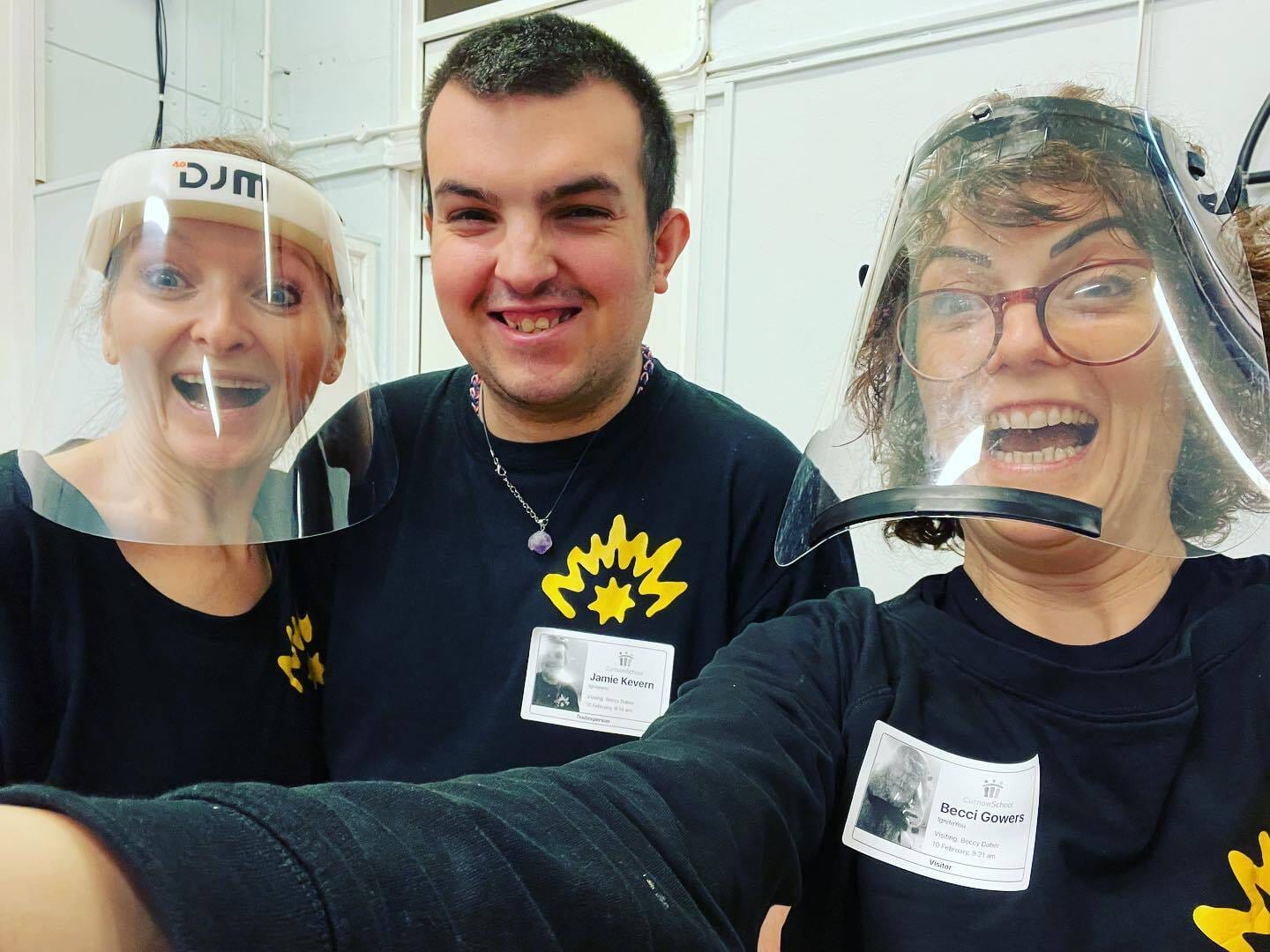 Selfie image of dance instructors wearing clear masks