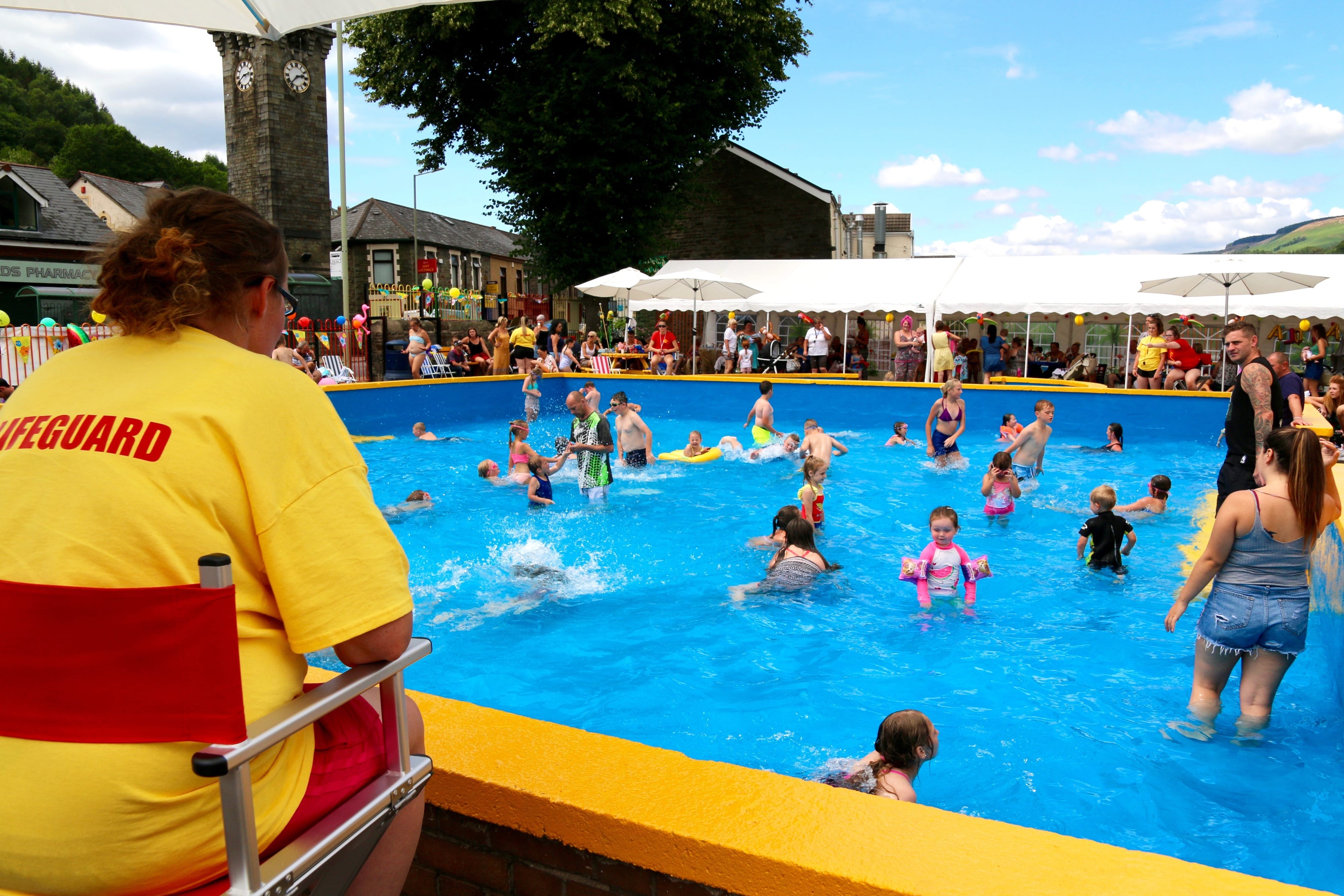 Volunteer lifeguard watches over people enjoying Lee Gardens Pool