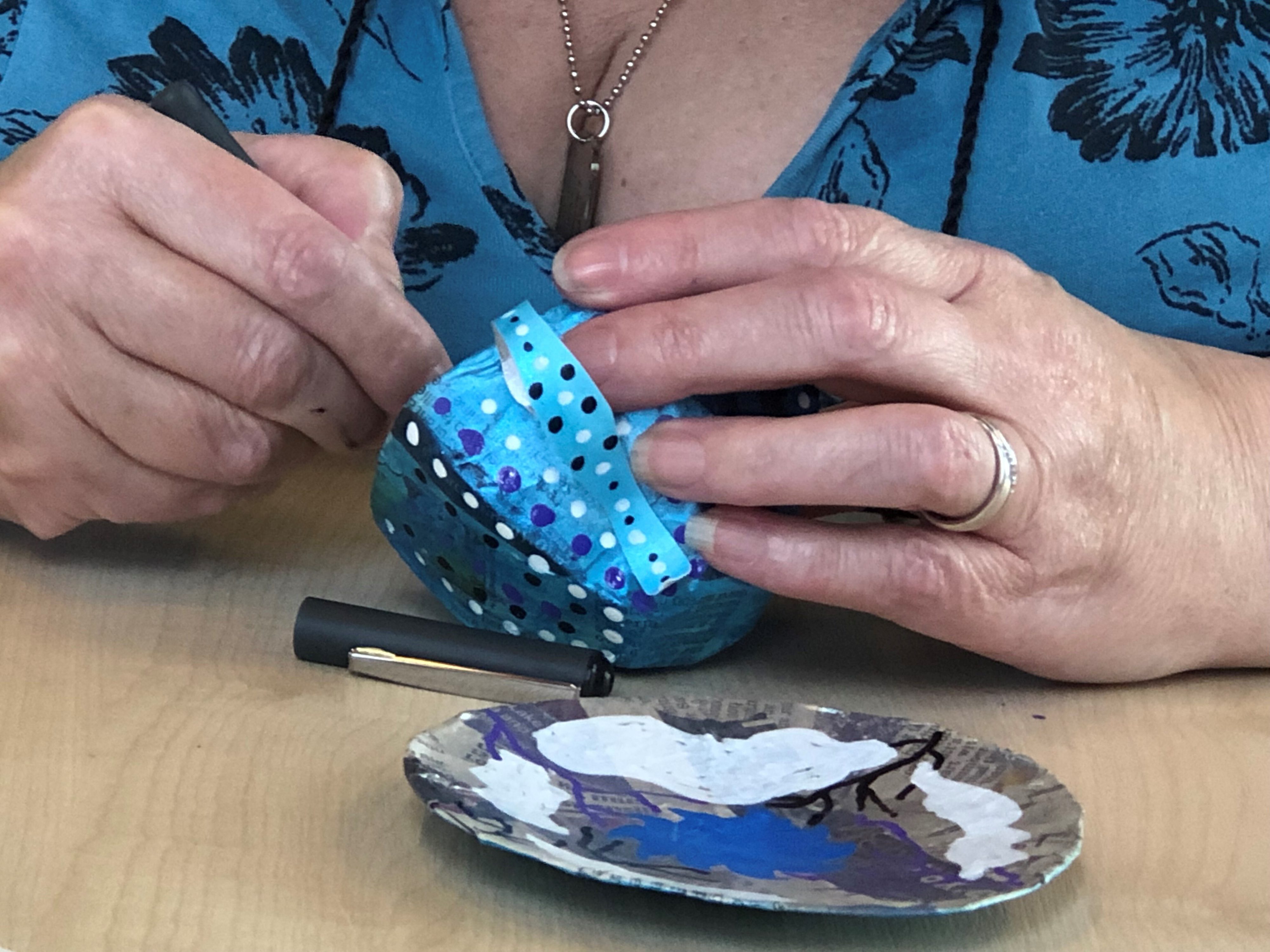 a hand made cup and saucer being painted