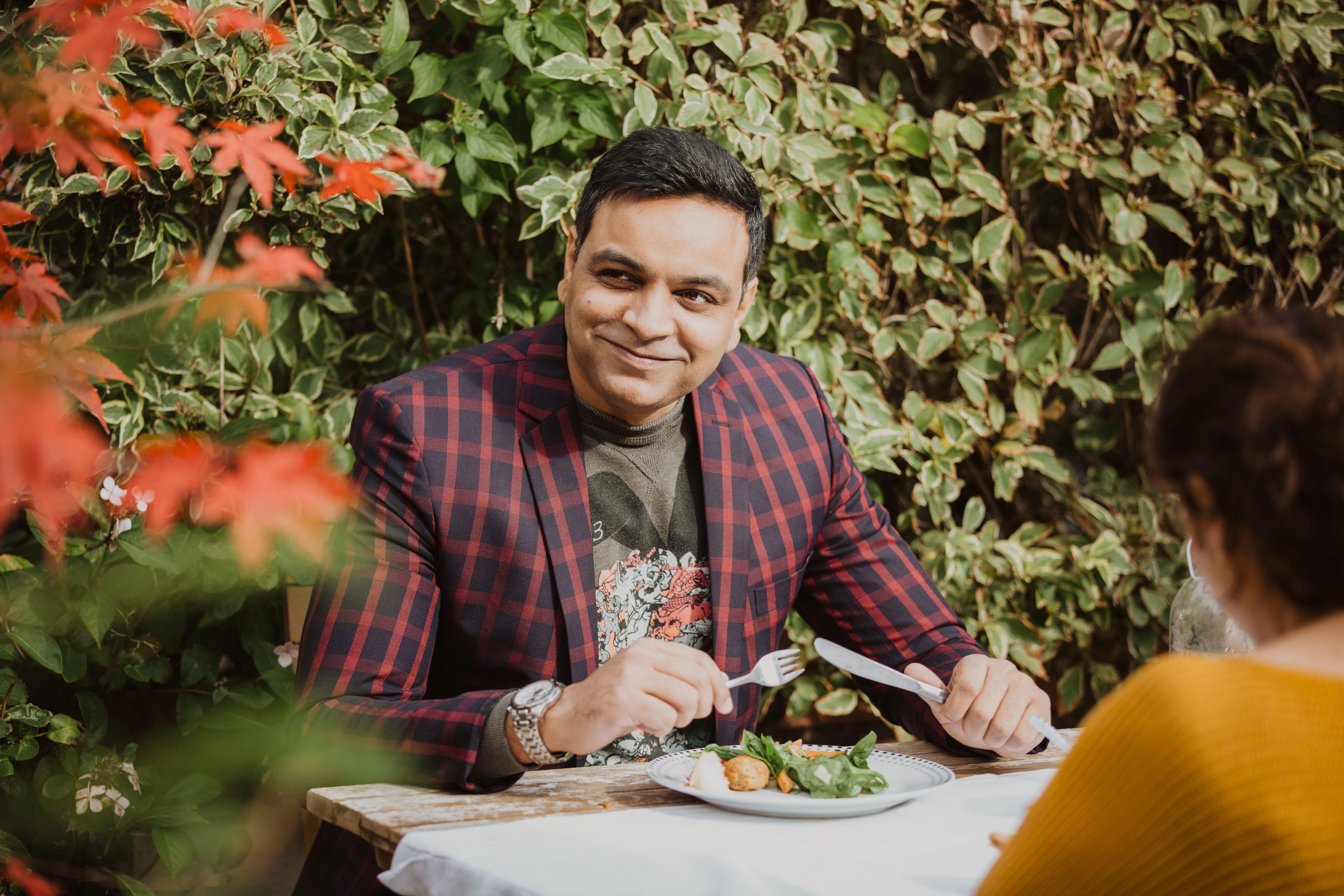 A participant of Refugee Roots sharing a meal with other participants