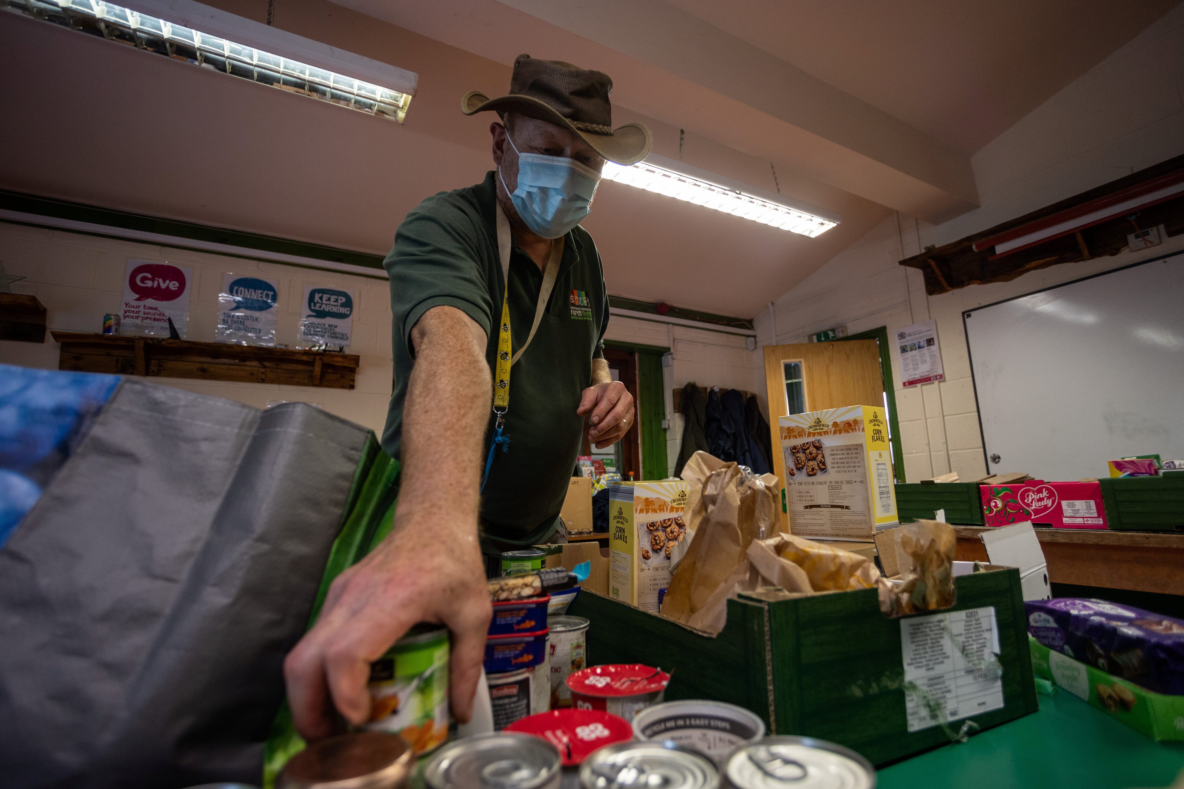 A person packs a food parcel at a community centre