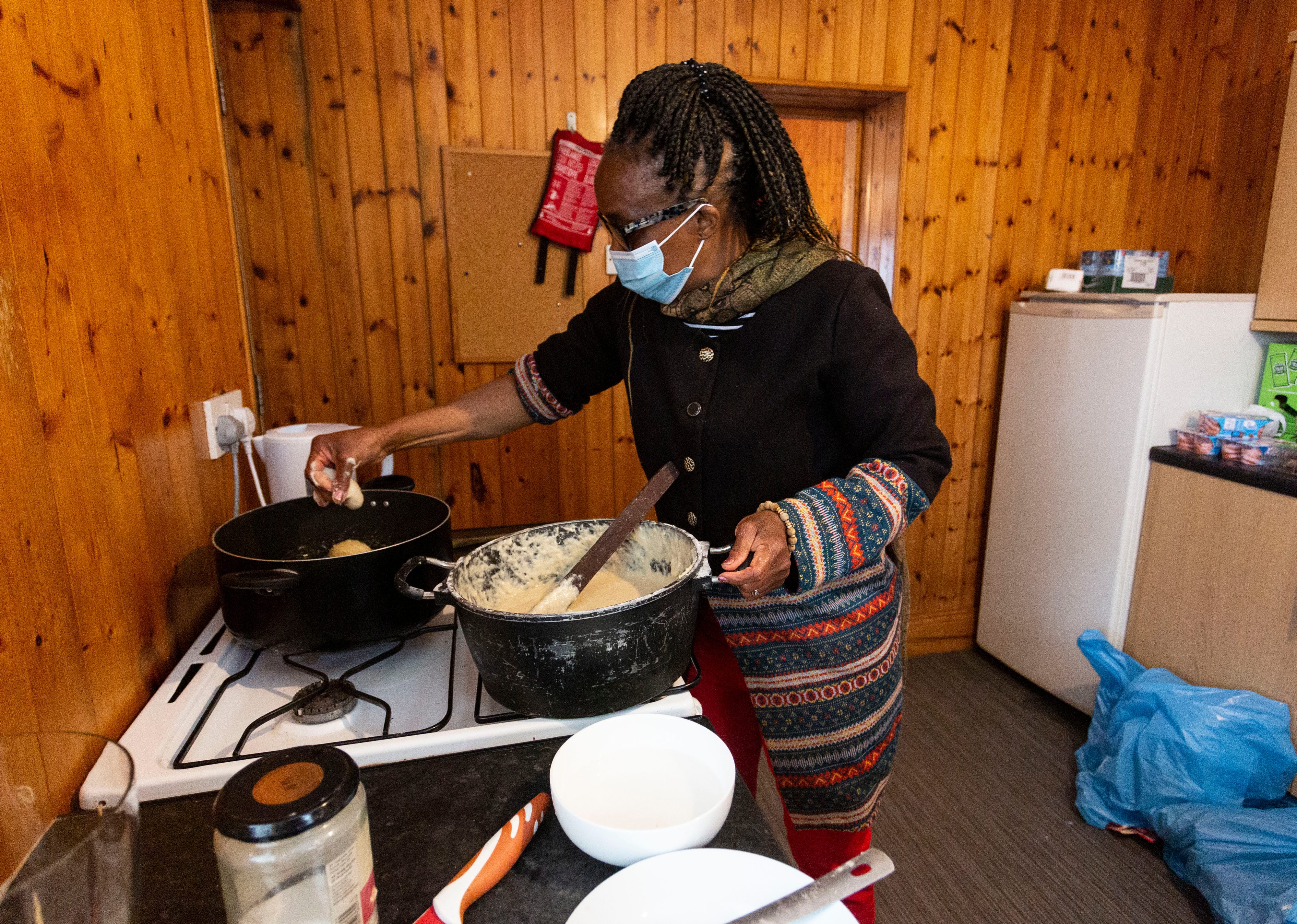 A woman cooking in a kitchen at the community hub