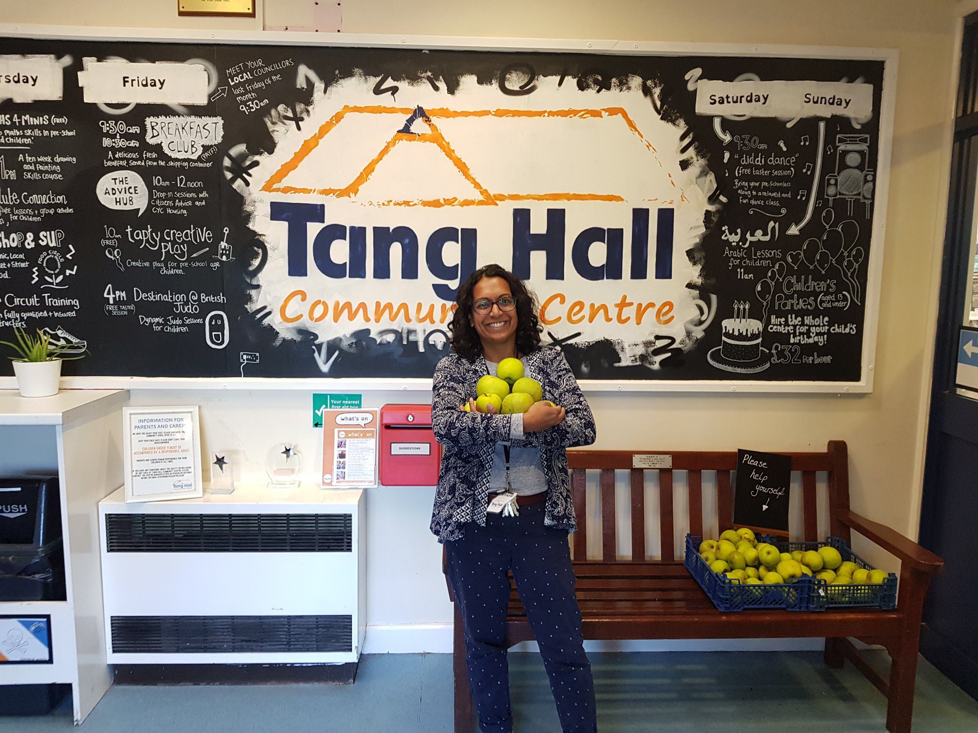 Woman stands in front of project poster with food