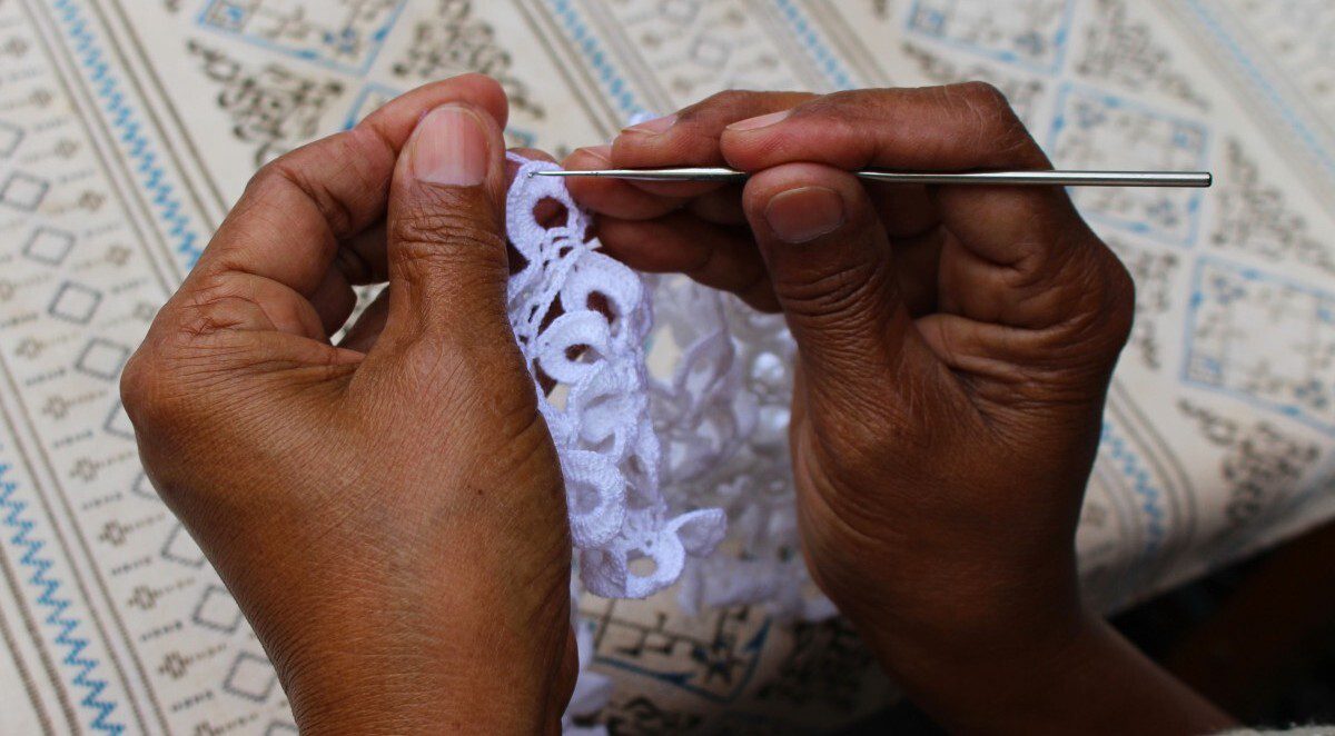 Close up of hands stitching material